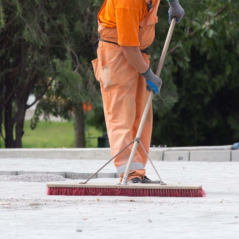 Worker sweeping on a construction site