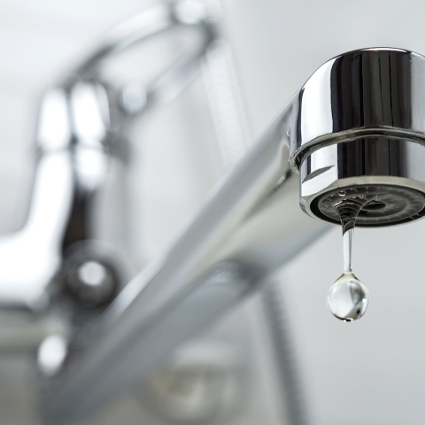 Water dripping from a sink faucet