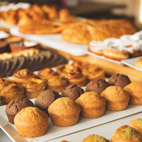 Row and trays of baked goods at a bakery