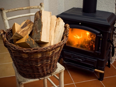 Basket of logs in front a burning fire