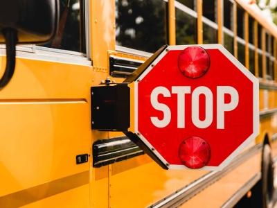 A school bus with its stop sign extended