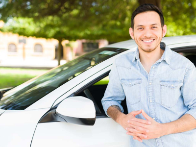 A driver standing next to a car