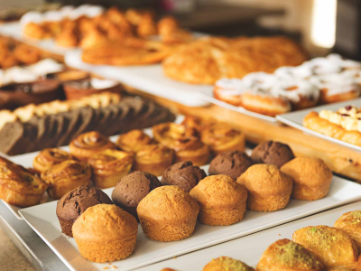 Row and trays of baked goods at a bakery