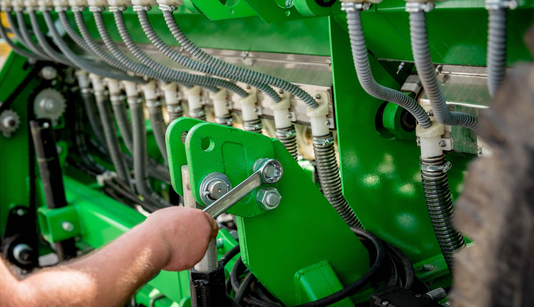 Mechanics repair a combine harvester