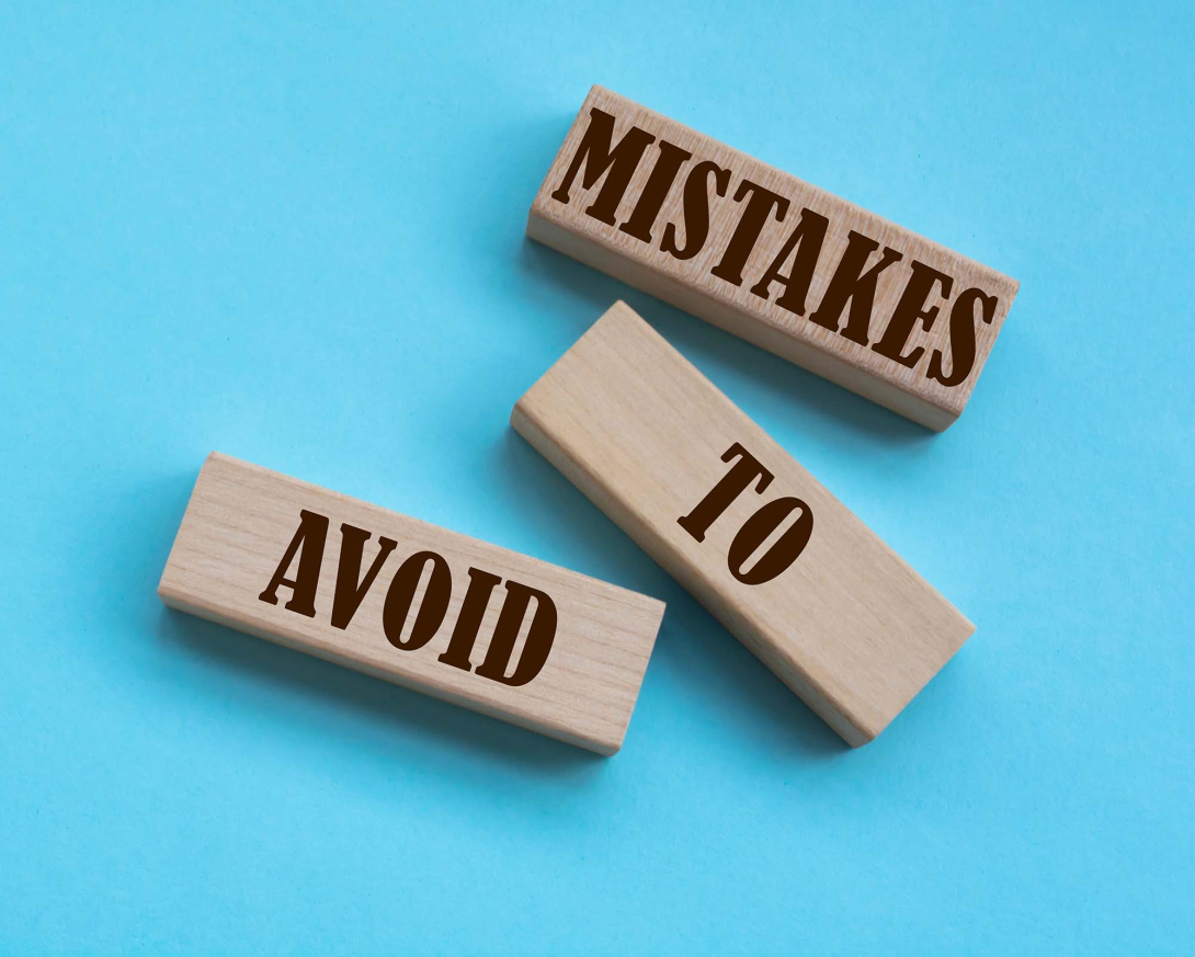 Mistakes to Avoid words written on wooden blocks on a blue background
