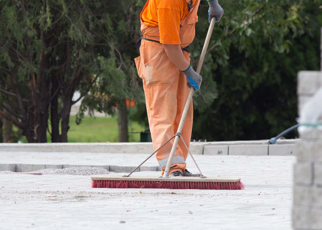 Worker sweeping on a construction site