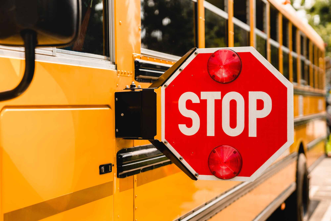A school bus with its stop sign extended