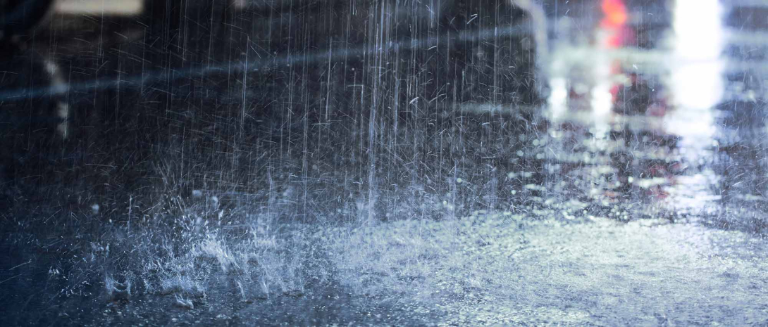Rain falling on a dark road