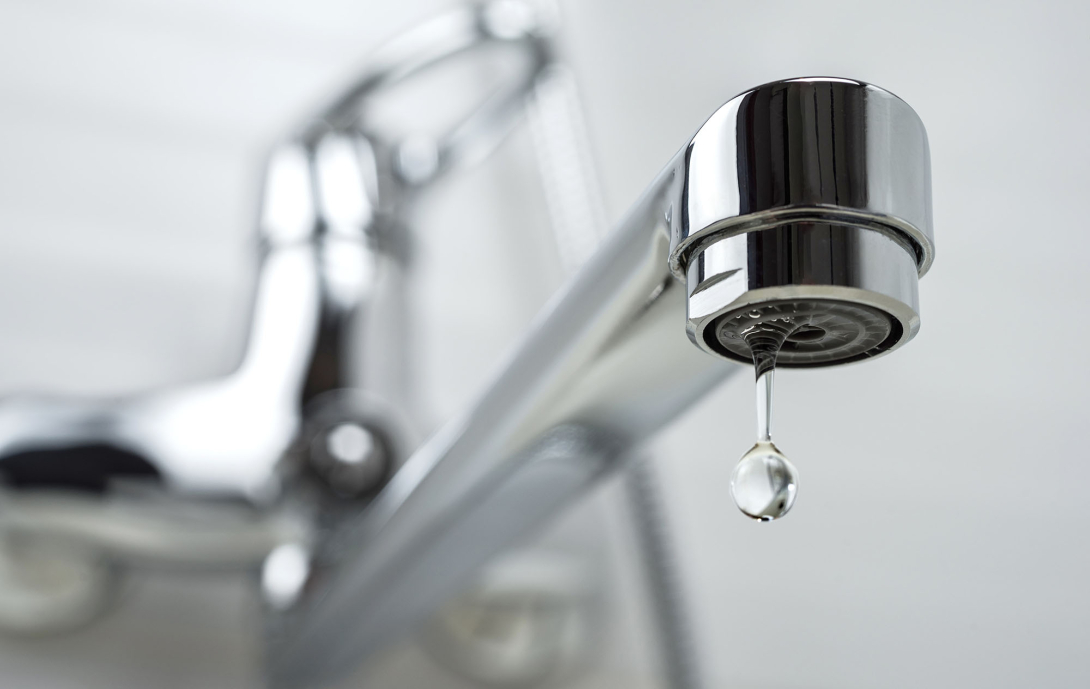 Water dripping from a sink faucet