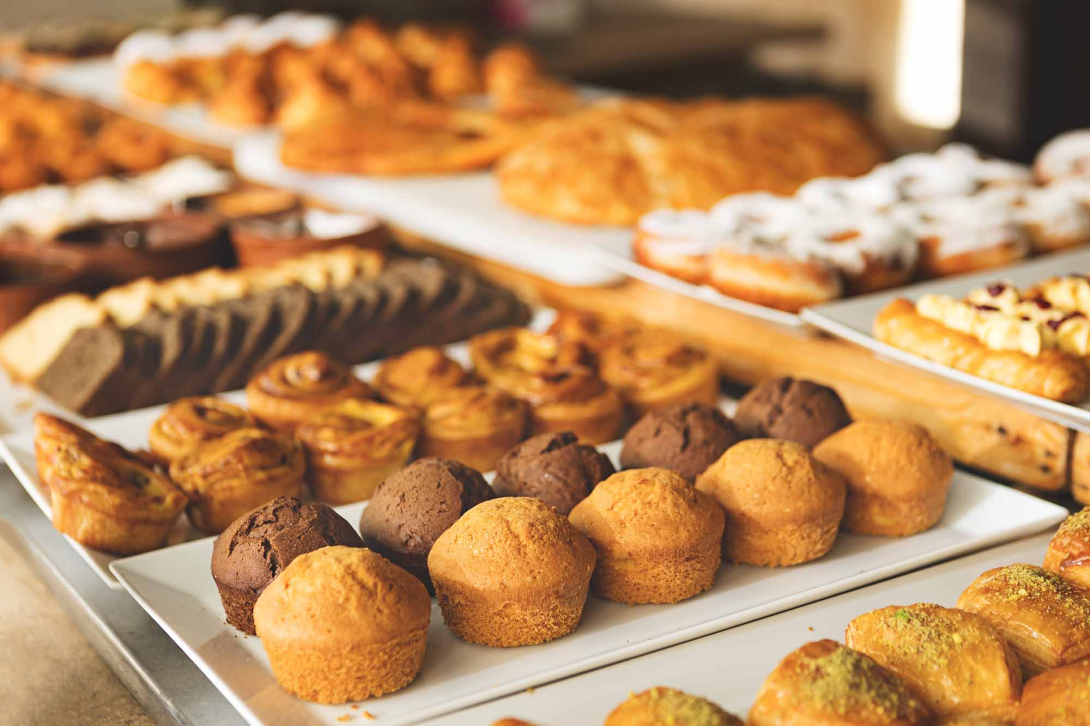 Row and trays of baked goods at a bakery